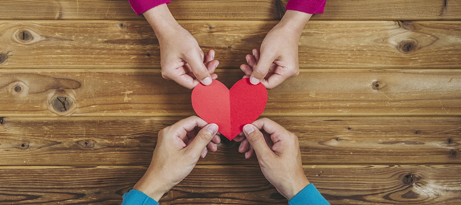 Eleo Donor Matching Gifts with a boy and girl holding a heart envelope